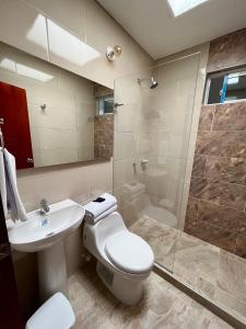 a bathroom with a toilet and a sink and a shower at Hotel Boutique Casa Pere in Cartagena de Indias