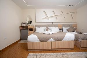 Кровать или кровати в номере Camel Pyramids View Inn