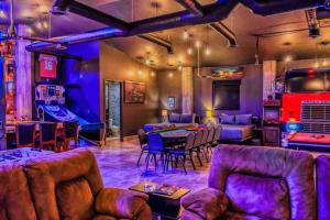 a room with a ping pong table and couches at Unique FAMILY CAVE Heated Pool on demand in Puerto Peñasco