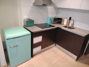 a small kitchen with a refrigerator and a sink at DREAM STUDIO PORT XABIA in Jávea