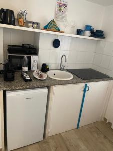 a small kitchen with a sink and a counter at Porta Blu Apulia in Martina Franca