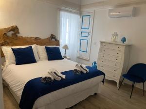 a bedroom with a bed with shoes on it at Porta Blu Apulia in Martina Franca