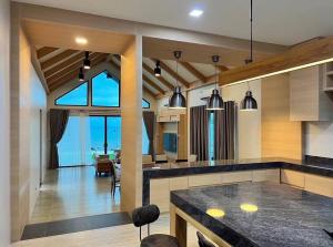 una cucina con un tavolo e una sala da pranzo di Rainy House By Serenity Sea House a Ban Khao Khwang (2)
