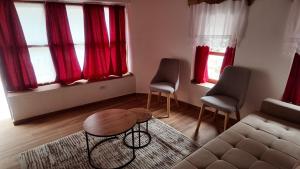 a living room with a couch and two chairs at Suite of Bazaar in Gjirokastër +1 photo
