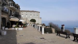 a walkway with two benches and a building at Residence "I Centralissimi Mamiblu' " in Vasto