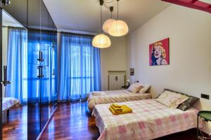 a room with two beds and a couch in it at Urban House - un angolo di relax con terrazza in Lombardia in Limbiate