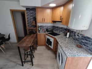 a kitchen with wooden cabinets and a counter top at Casa Chusky in Broto +7 photos