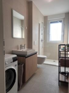 a bathroom with a washing machine and a sink at Apartman MINI MI 2 in Zagreb