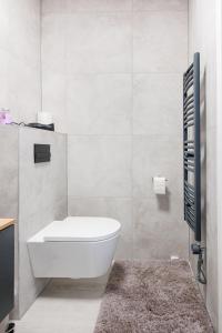 a white bathroom with a toilet and a sink at Sissi Apartments in Vienna