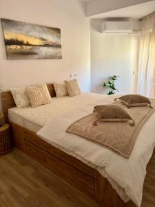 Un dormitorio con una cama grande con almohadas. en Ares Peñiscola, en Peñíscola