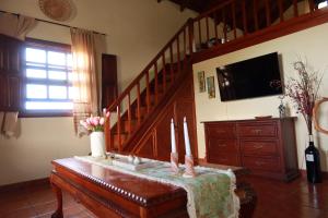 a living room with a table with candles on it at Casa Las Sabinas in Guarazoca