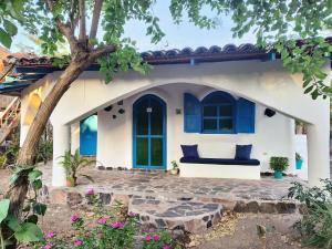 a house with a couch in the front of it at La Urraca Loca Hostel in Balgue