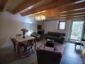 a living room with a table and a couch at Casa de Condeixinha in Condeixa a Nova