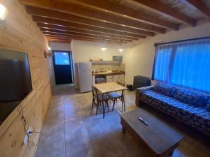 a living room with a couch and a table at Apu Wasi in Villa La Angostura