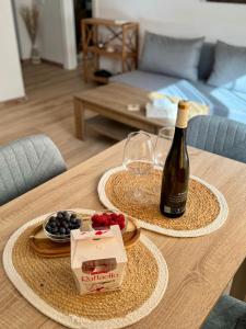 una mesa con una botella de vino y una caja de uvas en Ares Peñiscola, en Peñíscola