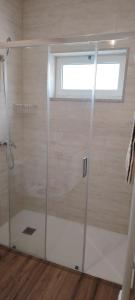 a shower with a glass door in a bathroom at Casa Mondinense in Mondim de Basto