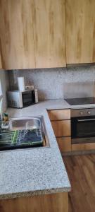 a kitchen with a sink and a microwave at Casa Mondinense in Mondim de Basto