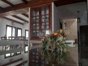 a dining room with a table and a vase of flowers at Casa Rural Solanilla in Solanilla +1 photo