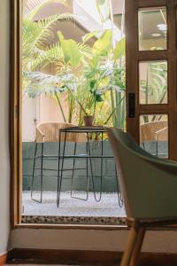 a table and a chair in front of a door at Poblado Muuk Hotel Boutique Campestre in Medellín
