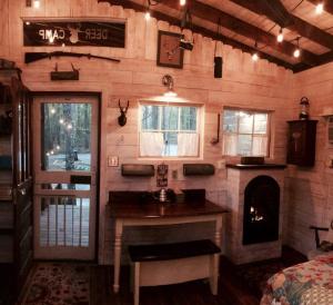 a room with a kitchen and a fireplace in a house at Glamping at Deer Camp in Dunlap