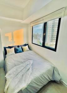 a bedroom with a bed with a large window at Casa Azul Serin East Tagaytay in Tagaytay