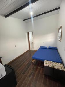 a bedroom with a blue bed and a wooden floor at Kit net great price in São Sebastião +35 photos