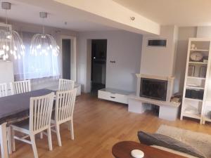 a kitchen and dining room with a table and chairs at Quiet and cozy apartment Wroclaw-Widawa in Wrocław