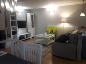 a living room with a couch and a table at Quiet and cozy apartment Wroclaw-Widawa in Wrocław