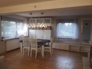 a kitchen and dining room with a table and chairs at Quiet and cozy apartment Wroclaw-Widawa in Wrocław