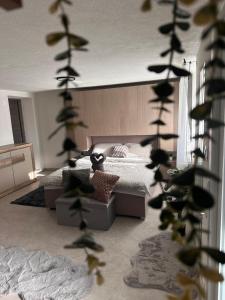 a bedroom with a bed and a plant in the foreground at Stanojkov in Bovec