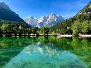 a lake in the middle of a valley with mountains at Stanojkov in Bovec