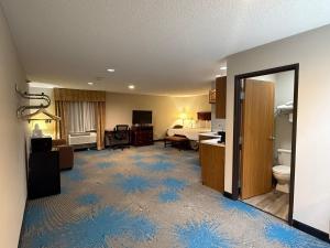 a hotel room with a bathroom with a bed and a room at Days Inn by Wyndham Sturgis SOUTHDAKOTA in Sturgis