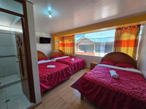 Postel nebo postele na pokoji v ubytování HOSTAL ACUARIUS PUNO