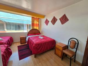 Postel nebo postele na pokoji v ubytování HOSTAL ACUARIUS PUNO