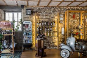 a shop with a vespa in a stone wall at Hotel Casa de Caldelas in Castro Caldelas