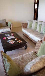 a living room with a couch and a coffee table at Ocean Plateau in Motu Tiahura