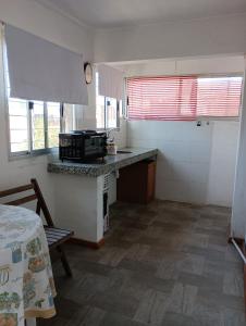 a kitchen with a counter and a stove in it at Apartamento en Paysandu in Paysandú +1 photo
