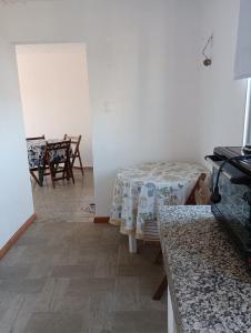 a living room with a table and a dining room at Apartamento en Paysandu in Paysandú