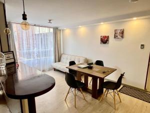a living room with a table and chairs and a couch at Duplex La Villa - Sogamoso Centro in Sogamoso