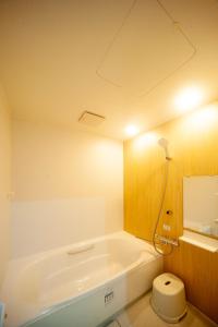 a bathroom with a bath tub and a toilet at beppu turu 鶴 in Beppu +35 photos