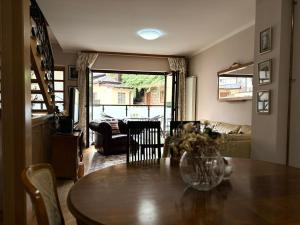 a dining room with a table and chairs and a living room at Villa Heritage - Old Town - PRIVATE GARAGE in Sarajevo