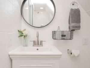 a bathroom with a white sink and a mirror at Jennifer's Historic College Hill Apartment - The Lookout in Providence