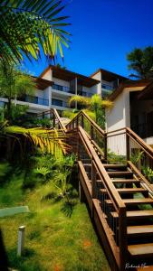 a wooden staircase leading to a building with a building at Céu do Morro in Morro de São Paulo
