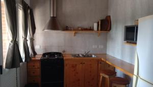 a kitchen with a black stove and a sink at Tierra Mia in Carpintería