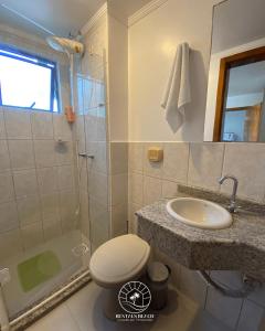 a bathroom with a shower and a toilet and a sink at Apto no centro de Torres | Aceita Pet in Torres
