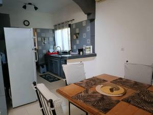 a kitchen with a wooden table and a kitchen with a counter at Villa Na aldiana in Sali Nianiaral
