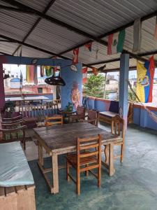 a restaurant with a wooden table and chairs at Zumag Sisa in Tena