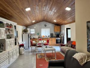 a living room with a couch and a table at Maison L aurore in Lobios