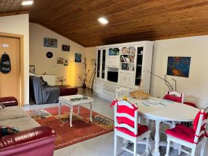 a living room with a white table and chairs at Maison L aurore in Lobios +33 photos