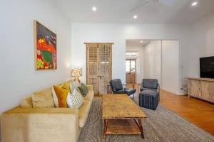 a living room with a couch and a coffee table at Luxury Couples Stay Bangalow l Nova Escapes in Bangalow
